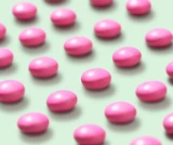 Photograph of a dozen Dulcolax For Women tablets laying on a light green background