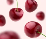 Photo d’une douzaine de cerises flottant sur un fond rose pâle pour mettre en valeur le goût de DulcoLax Liquide