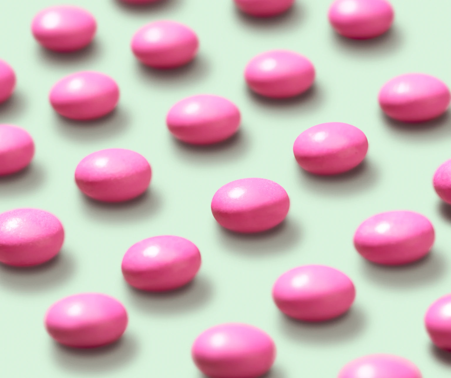 Photograph of a dozen Dulcolax For Women tablets laying on a light green background