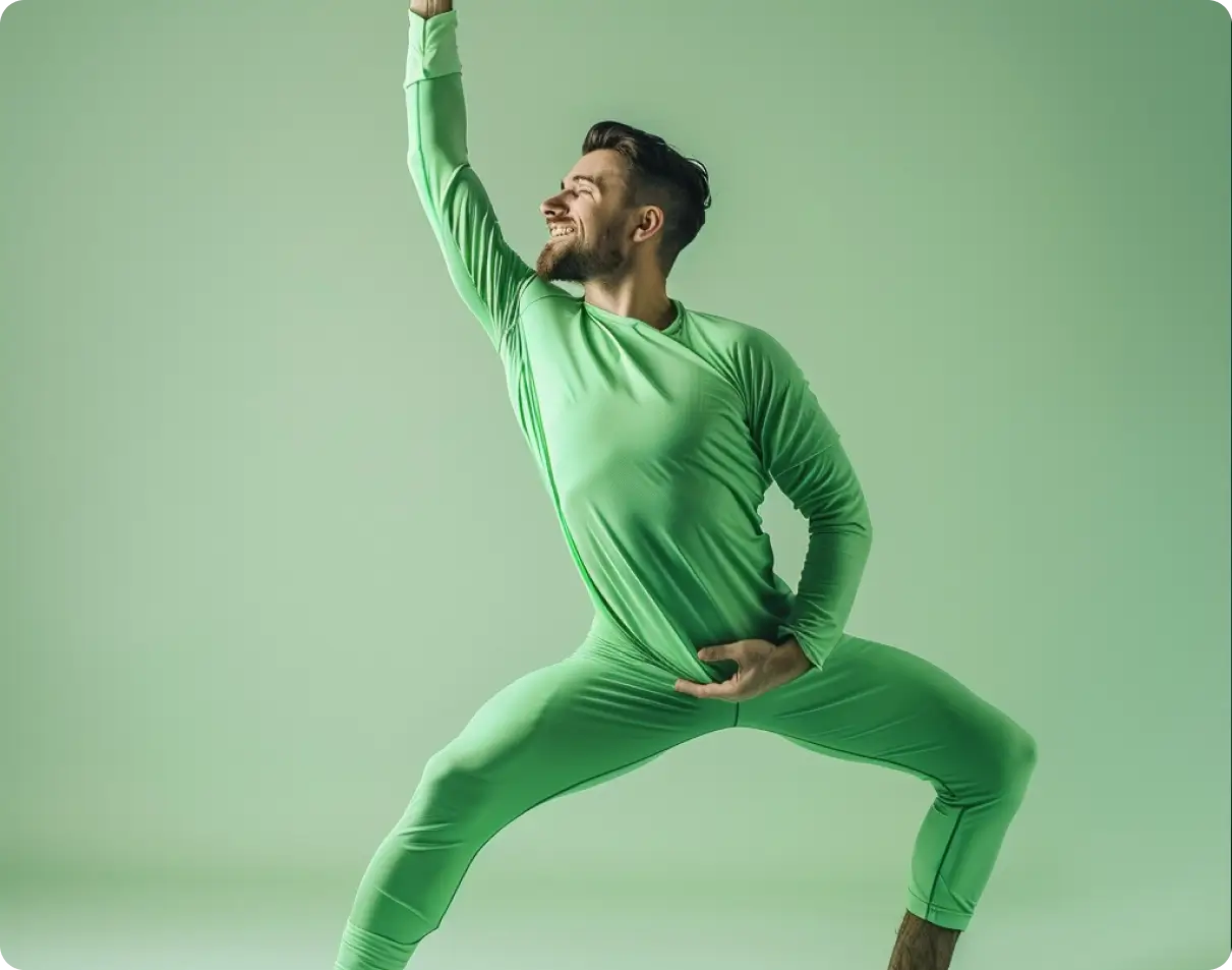 Man in a green outfit striking a dynamic pose against a green background.